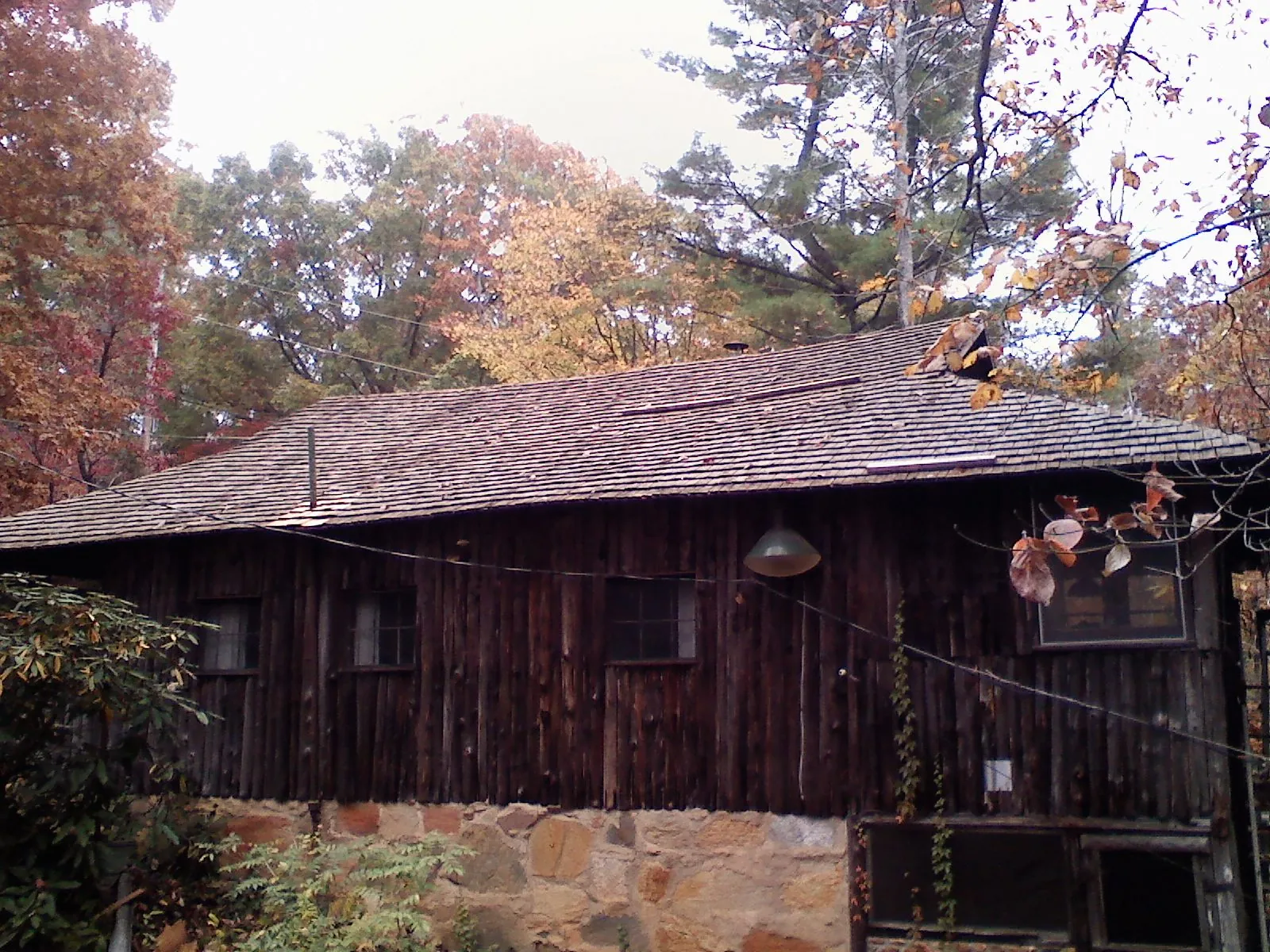 Weathered wood shake roof on a rustic board sided cabin in Harrodsburg