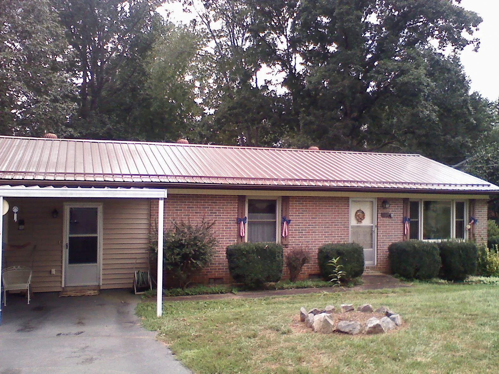 Bronze metal roof and carport on a brick ranch home — Roof Repair work by our crew in Harrodsburg