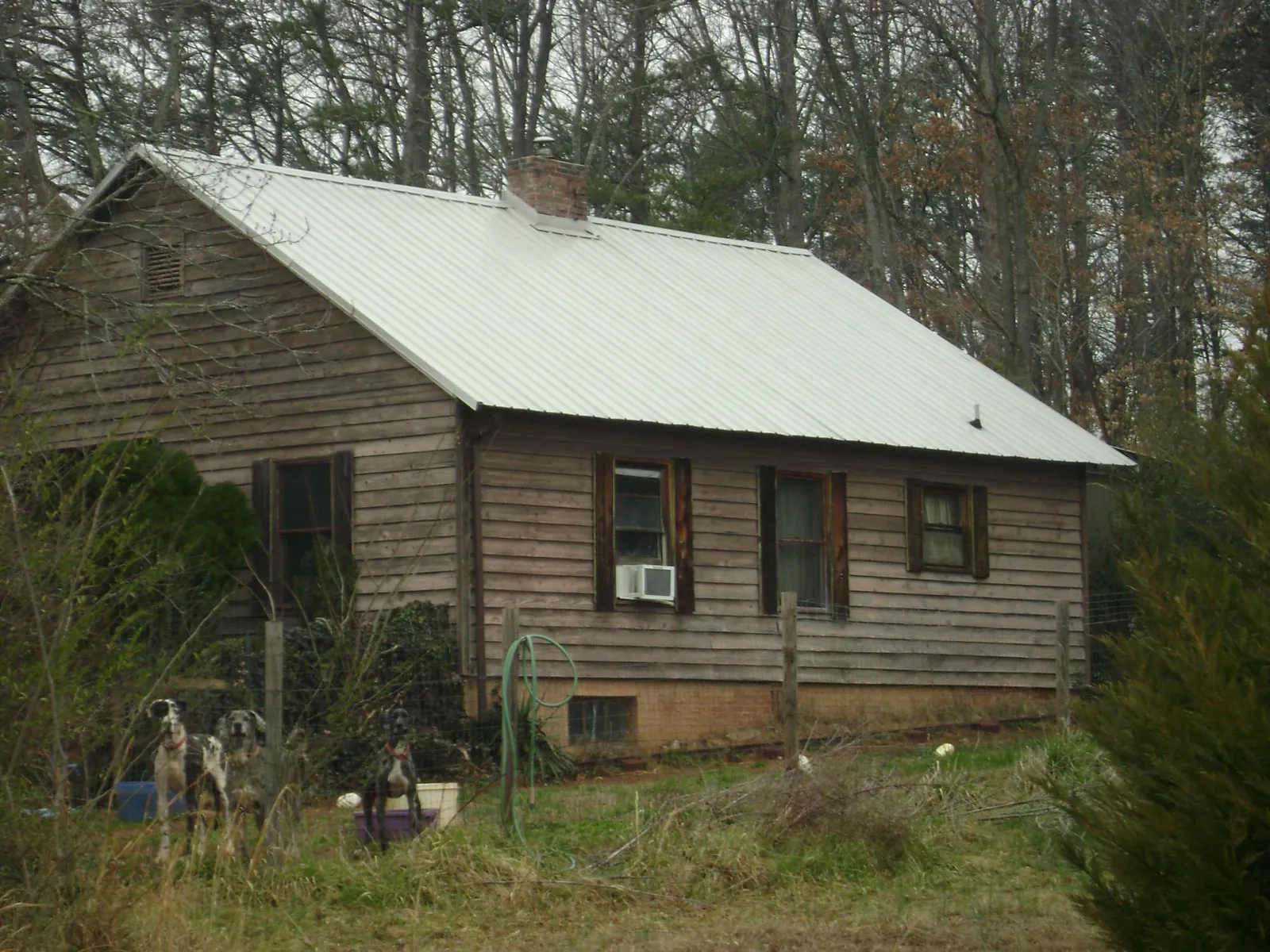 White metal roof on an old wood sided farmhouse, from a Metal Roof Installation job in Harrodsburg